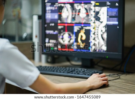 Hand holding mouse with blur Computed Tomography Aorta Angiography (CTA Aorta) background. Royalty-Free Stock Photo #1647455089
