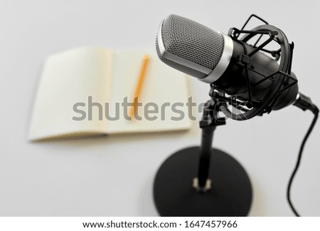 technology and audio equipment concept - close up of microphone on white background