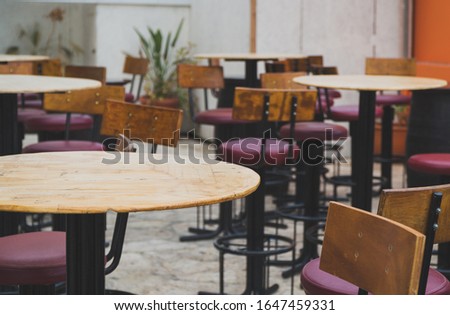 Outdoor cafe terrace exterior with chairs and tables.