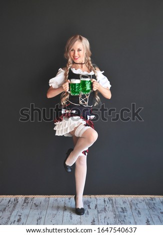 Woman with a glass of green beer. St. Patrick's Day.