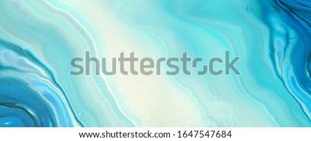 Very beautiful abstract ART background - random free mixing of paints in technique of liquid acrylic. Artistic image of swirl veins marble texture in blue turquoise tones, ultra wide format banner.