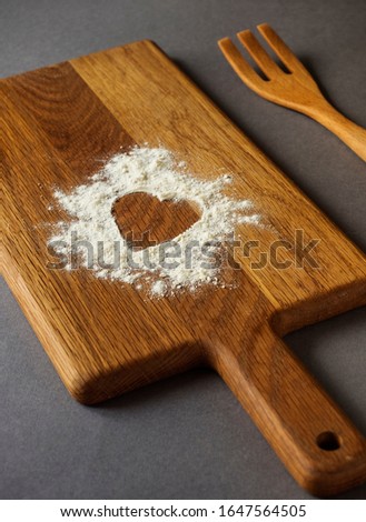 Hearts silhouette made of flour on a cutting board