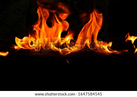 Blurry image of flames on a black background