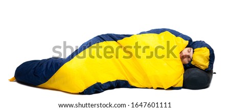 Man sleeping in sleeping bag. Isolated on a white background . Royalty-Free Stock Photo #1647601111