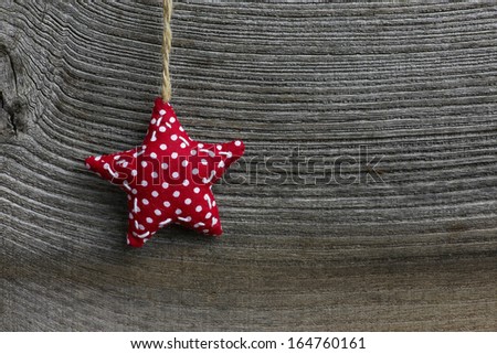 Christmas handmade decoration polka dot fabric star over rustic Elm wood background - retro style design, copy space