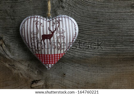 Christmas handmade decoration deer in tin heart over rustic Elm wood background - retro style design, copy space