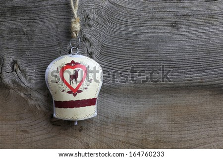Christmas handmade decoration deer on tin bell over rustic Elm wood background - retro style design, copy space