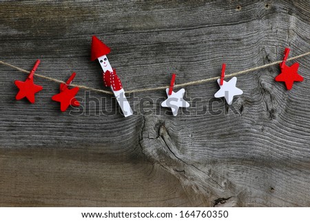 Christmas handmade decoration red and white wooden stars and white clip over rustic Elm wood background - retro style design, copy space