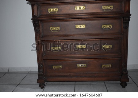 ancient dark wood cupboard with drawers