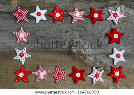 Christmas decoration red, white, gingham, stripes fabric stars with buttons  on rustic Elm wood background - retro style design, copy space