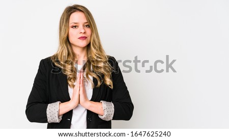 Young caucasian business woman isolated on white background Young caucasian bussines womanpraying, showing devotion, religious person looking for divine inspiration.