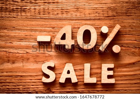 - 40 percent discount icon symbol on a wooden background. Minus forty percent. sale - word.