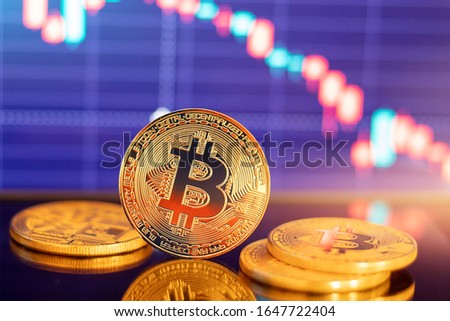 Gold Bitcoin crypto currency on background of chart diagram depreciation red dawn.