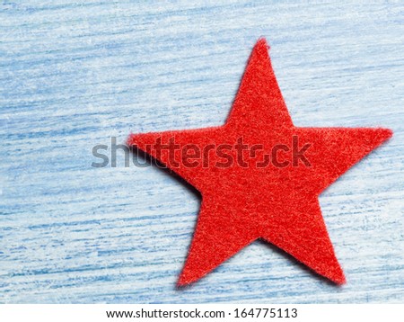 red felt star on blue wooden board