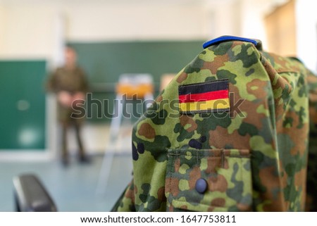 German soldier stands in a classroom . German word Bundeswehr, means german army. Royalty-Free Stock Photo #1647753811