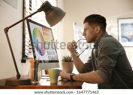 Professional designer working with computer in office