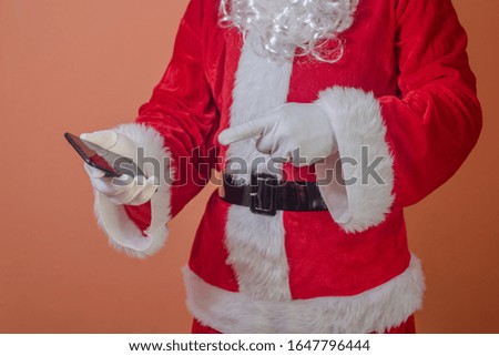 Santa Claus shows screen holding smartphone ready for holidays marketing