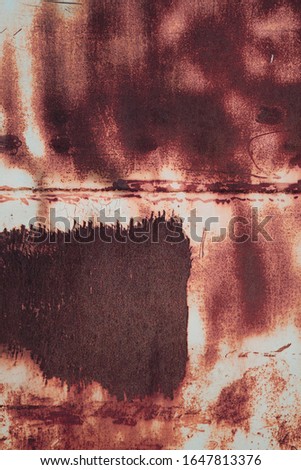 Rusty red metal grunge texture background. Old iron plate with scratches and peeled off white paint.
