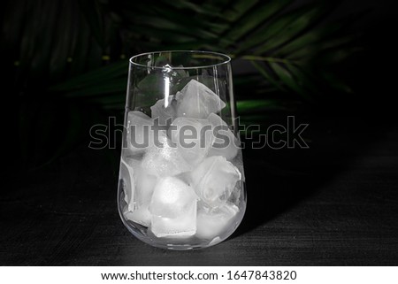 Clear glass for soft drinks. Added palm branches. Black background.
