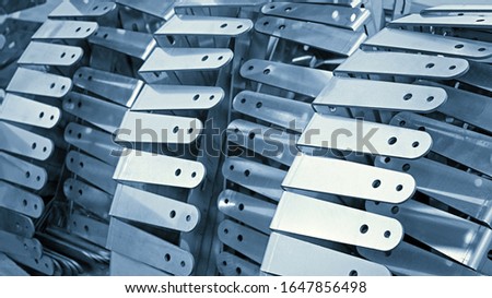 Closeup of a lot of steel parts for fixing equipment or finished products at an engineering plant. Abstract industrial background.