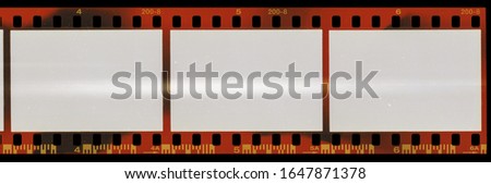 real scan of long 35mm film negative material with cool scanning light interferences or light marks on the material, empty photo film placeholder template, social media photo mock up.