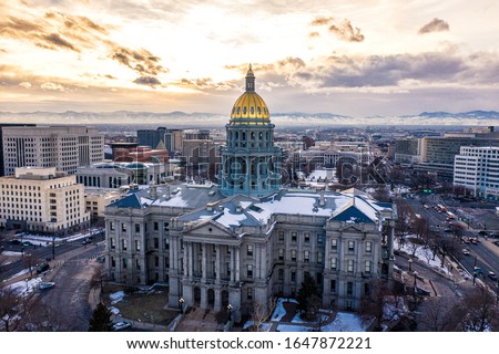 Colorado State Capitol Building & the City of Denver Colorado at Sunset. Rocky Mountains on the Horizon