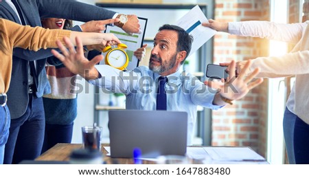 Group of business workers working together. Partners stressing one of them at the office Royalty-Free Stock Photo #1647883480