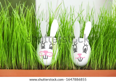 Easter eggs cute bunny in grass. Funny decoration. Happy Easter. Easter holiday concept with cute handmade eggs