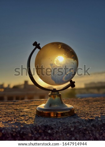 Picture of a globe on a table taken in morning