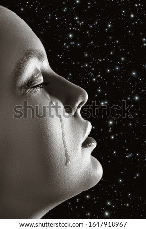 sad woman with closed eyes crying, on stars background, closeup portrait, profile view, monochrome
