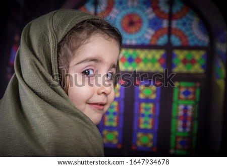 Happy muslim girl with hijab indoor. Portrait of a young Muslim girl