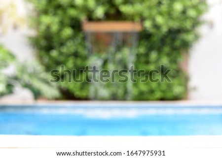 pool with blurred defocused waterfall for use as testura background
