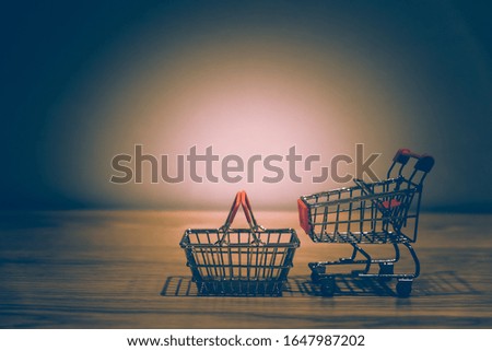 close-up of shopping cart and on vintage retro background with some copy space for texting.