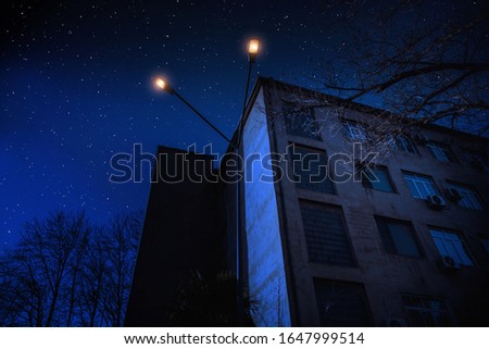 Beautiful landscape of building at forest at night with moon and stars. Scary abandoned house at night with ghost. Cold autumn night