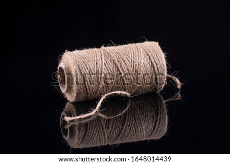 Skein of flax thread on a black background.