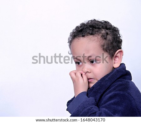child picking his nose on white background stock photo