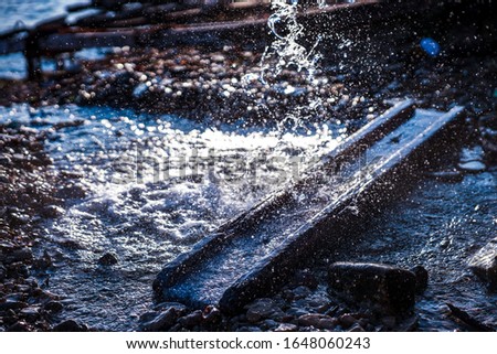 Water leaking from a pipe catched with fast shutter speed
