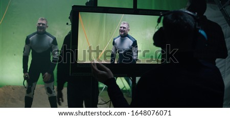 Medium shot of an actor forgetting his lines during shooting of scene and everybody laughing