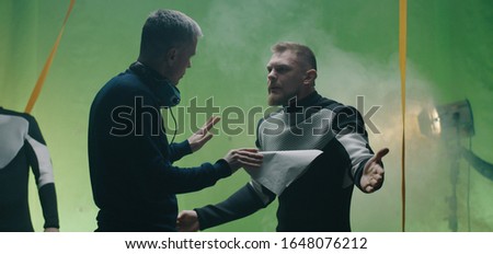 Medium shot of a hot-tempered actor quarreling with the director