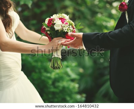Wedding couple holding hands, groom and bride together on wedding day. Royalty-Free Stock Photo #164810432