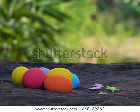 Colorful eggs on the wooden nature blur background.