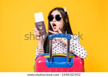 Tourist woman in summer casual clothes.Asian Smiling woman .Passenger traveling abroad to travel on yellow background.Asian woman going to summer vacation.Travel trip funny.