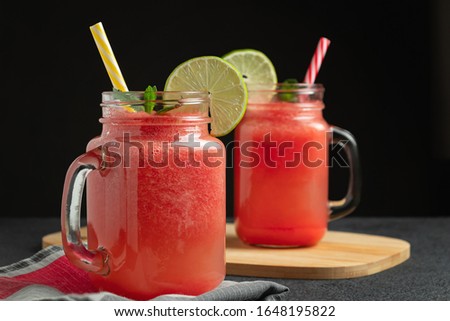 Watermelon smoothie with lime and mint in mug jars on a cutting board. Healthy eating concept