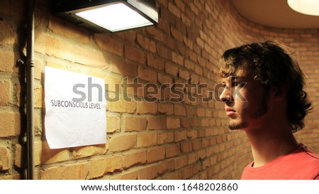 Man looking at dream sign in vintage brick room Royalty-Free Stock Photo #1648202860