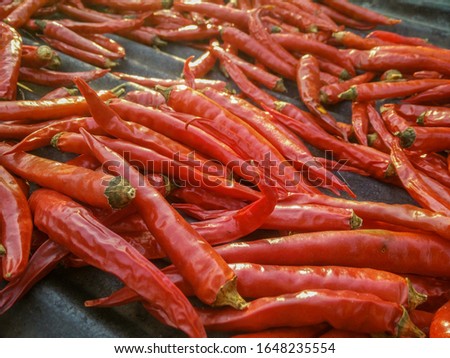 Red chili on galvanized sheet background, picture not clear, Not cofus in image.