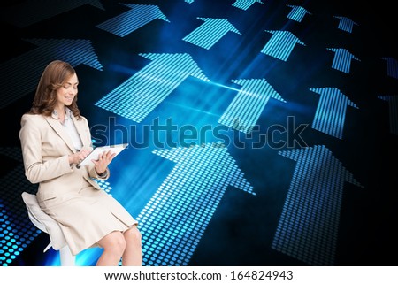 Composite image of happy brunette businesswoman using tablet