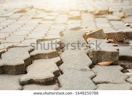 The floor of the footpath is broken. the footpath is uneven.May cause people to stumble and fall. Royalty-Free Stock Photo #1648250788