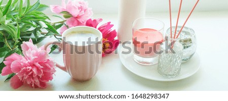 Vase with flowers on the windowsill. A cup of coffee by the window with a bouquet of pink peonies. March 8, Women's Day. Mother's Day. Beautiful romantic morning. Selective focus, banner