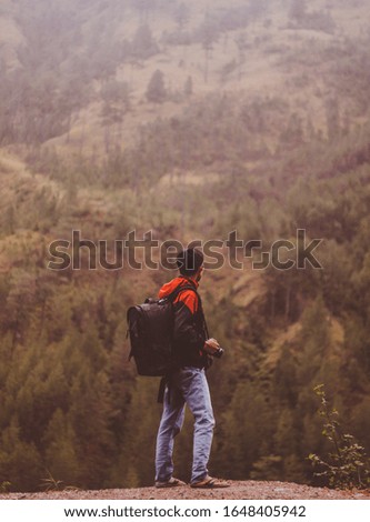 A man find new adventure in the forest with photography