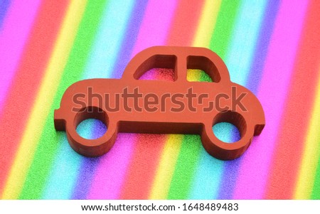 red toy car on colorful background